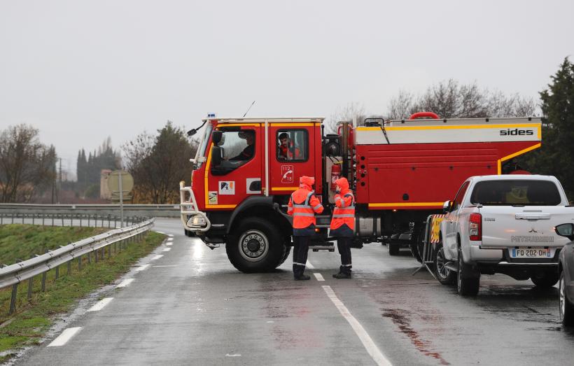 Un camion de pompiers barre une route inondée, dans l'Aude